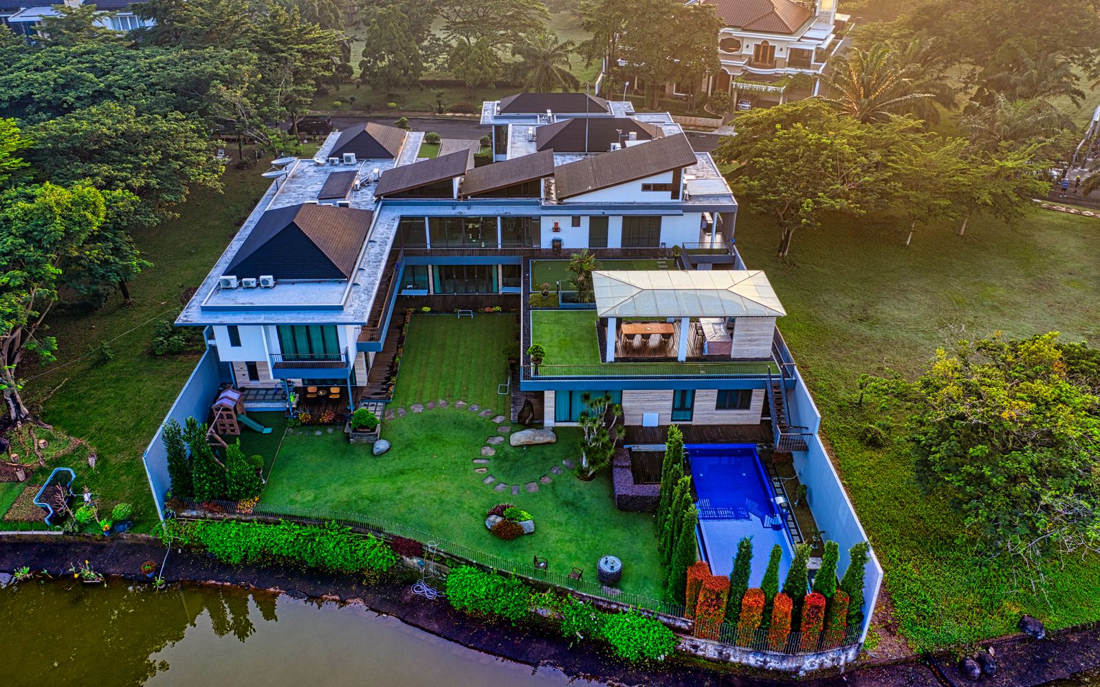 Stunning aerial view of a luxury villa by the river in Tangerang, Indonesia.