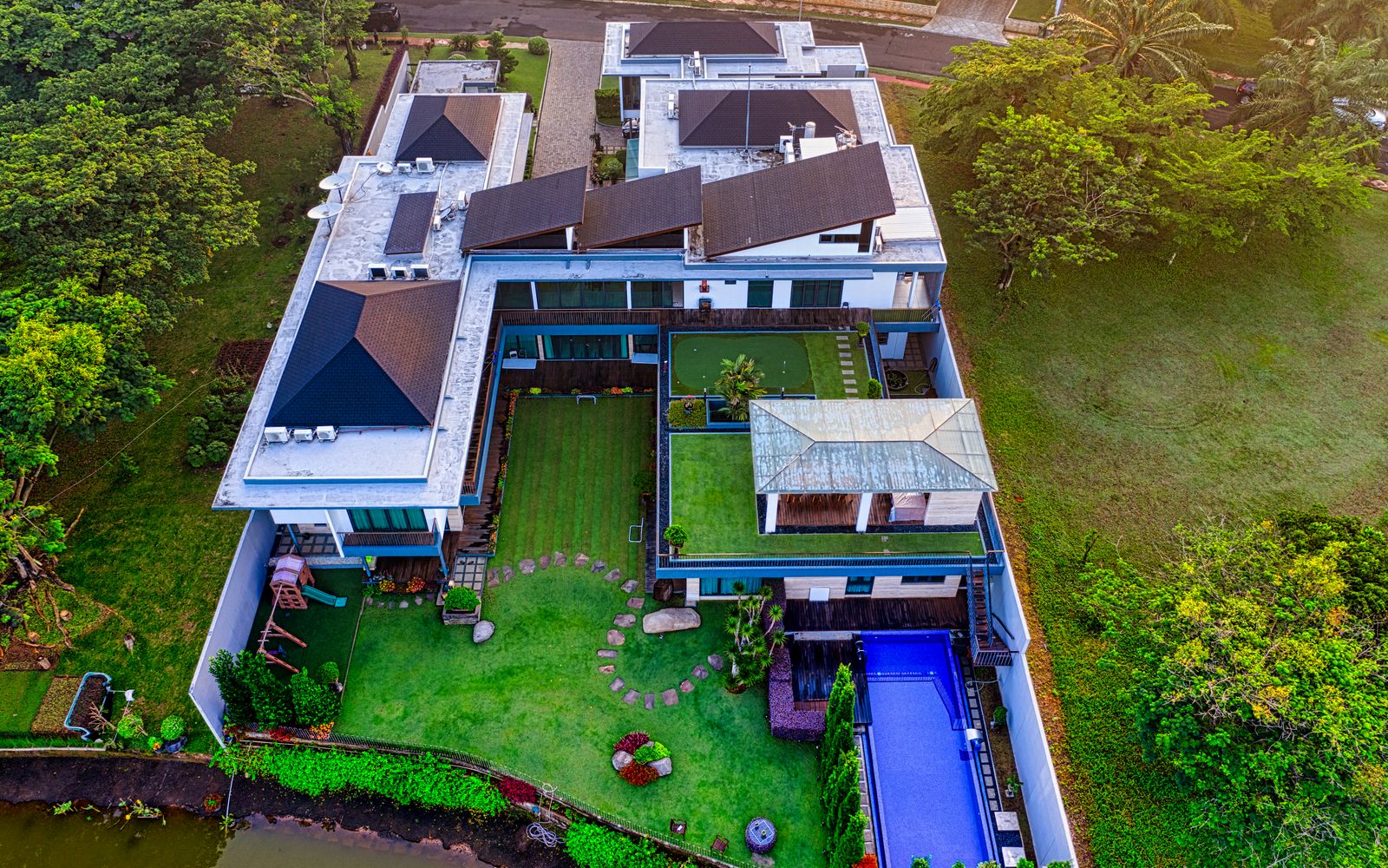 A stunning aerial view of a luxury riverside mansion in Tangerang, Indonesia.