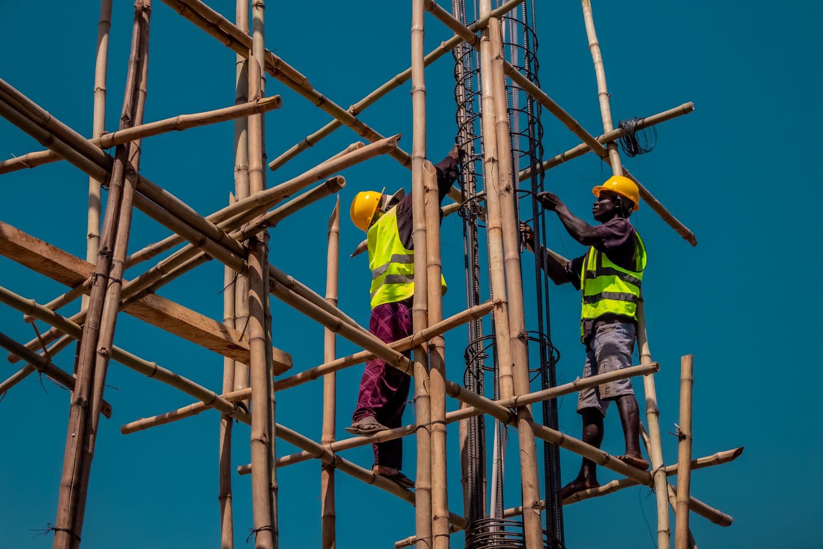 Construction workers on bamboo scaffolding
