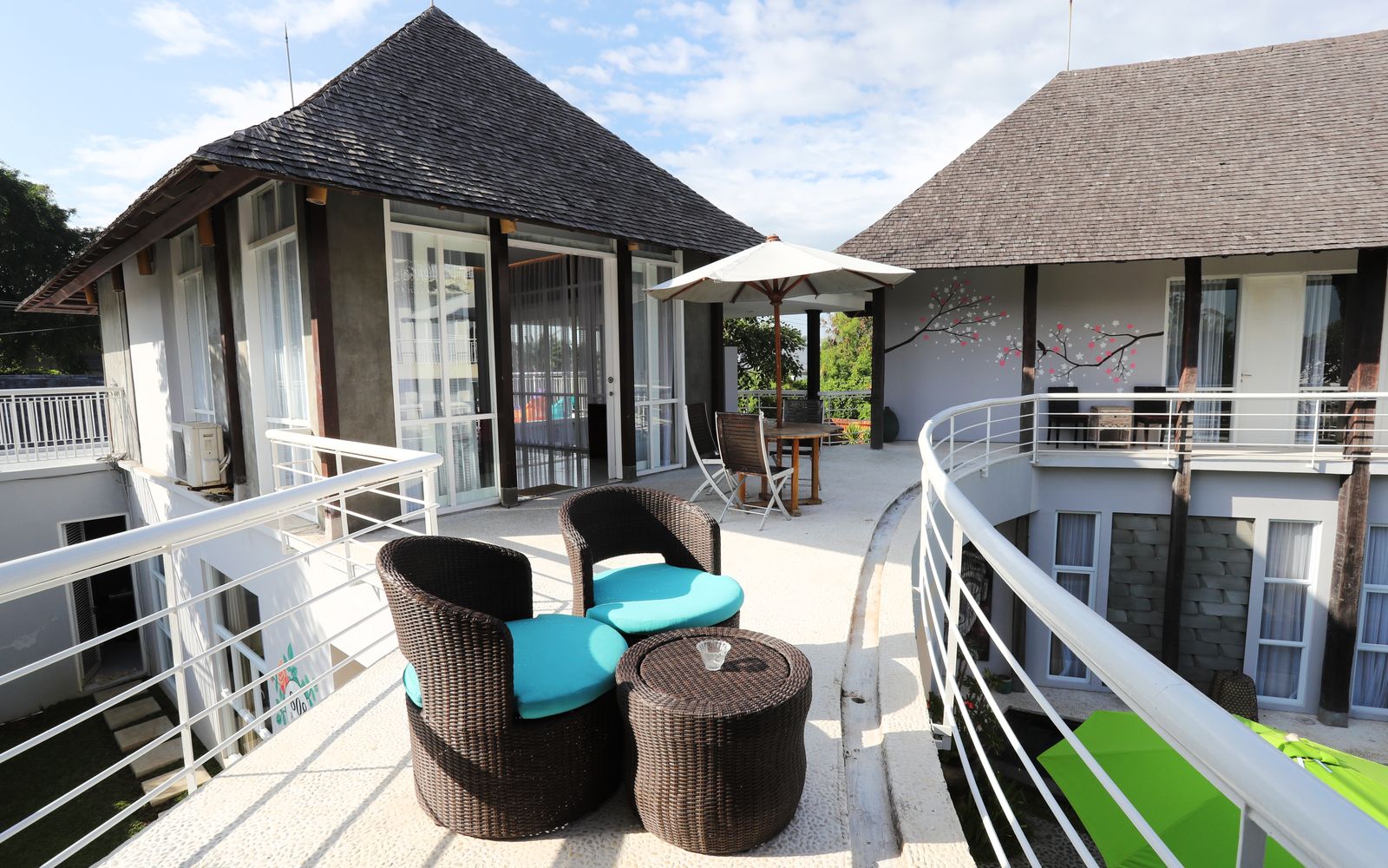 Stylish resort terrace in Bali featuring modern furniture and scenic outdoor view. Stylish resort terrace in Bali featuring modern furniture and scenic outdoor view.