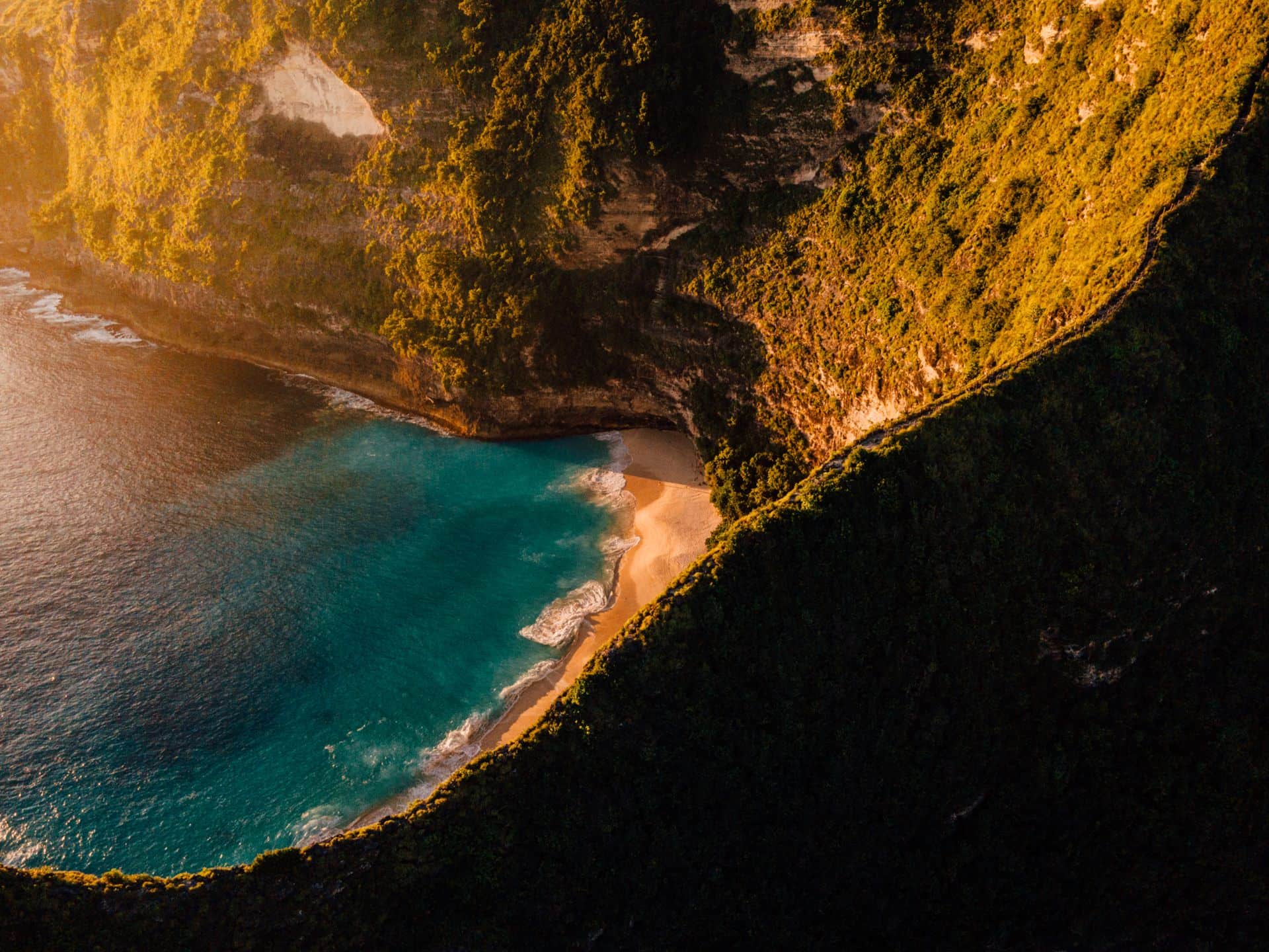 Aerial view of a Bali clifftop bay at sunset